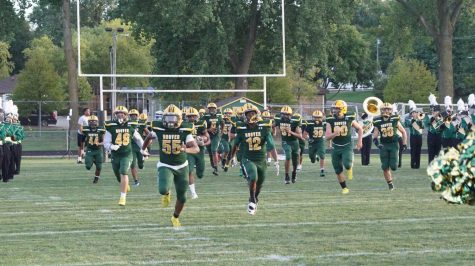 The Huskies take the field against Indianola High School, led by Senior, Romelo Spivey (55) MC Photography Photo