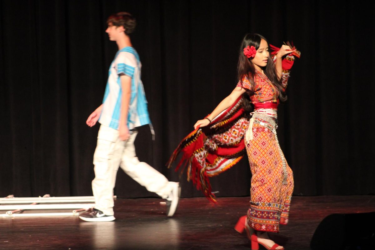 Freshman Ngun Men modeling Burmese clothing.