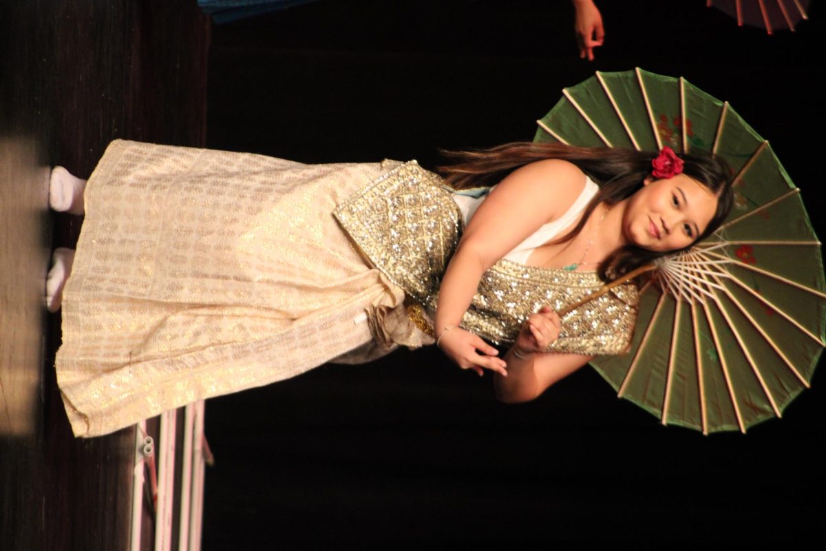 Junior Jacynda Swanson dancing in a Cambodian dress.